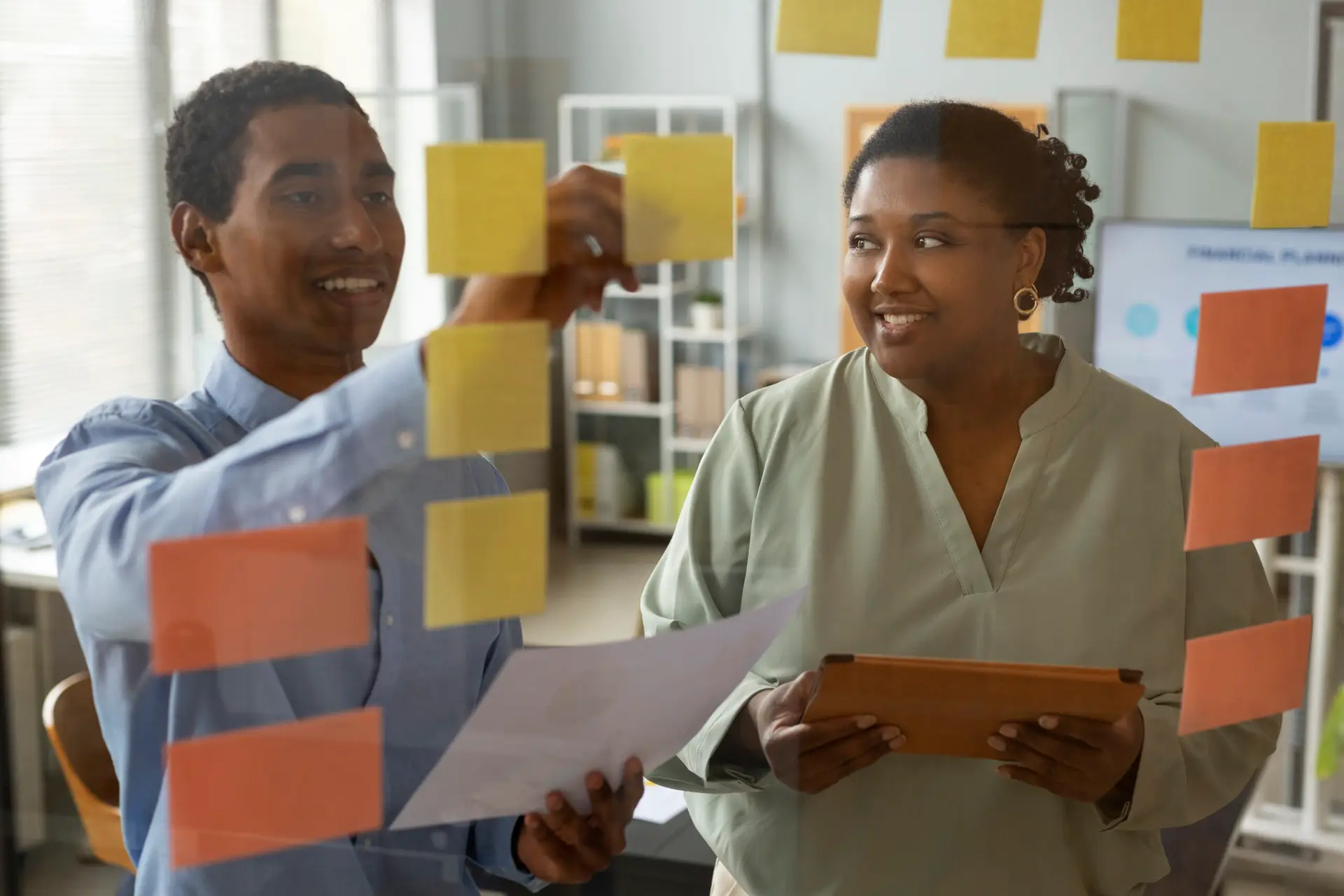 front view smiley people working with post its